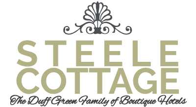 Logo for Steele Cottage, featuring elegant typography and a decorative crown motif.